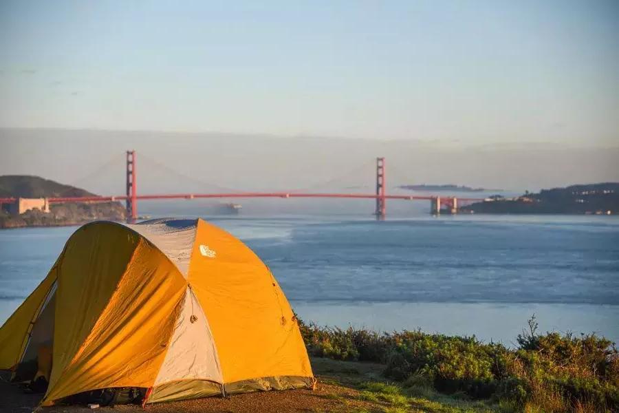 A tent in a campsite that overlooks the Golden Gate Bridge.